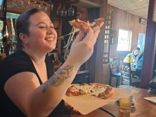 Enjoying Pizza at the Bar